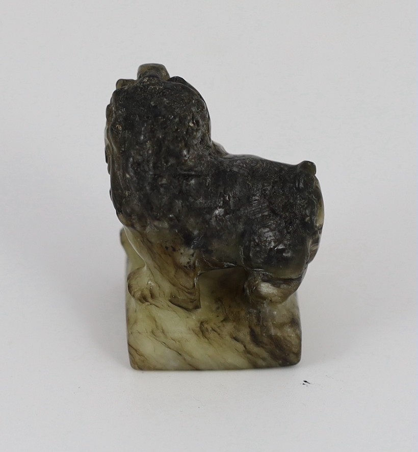 A Chinese pale celadon and black jade ‘lion-dog’ seal, 18th/19th century, 3.9cm high